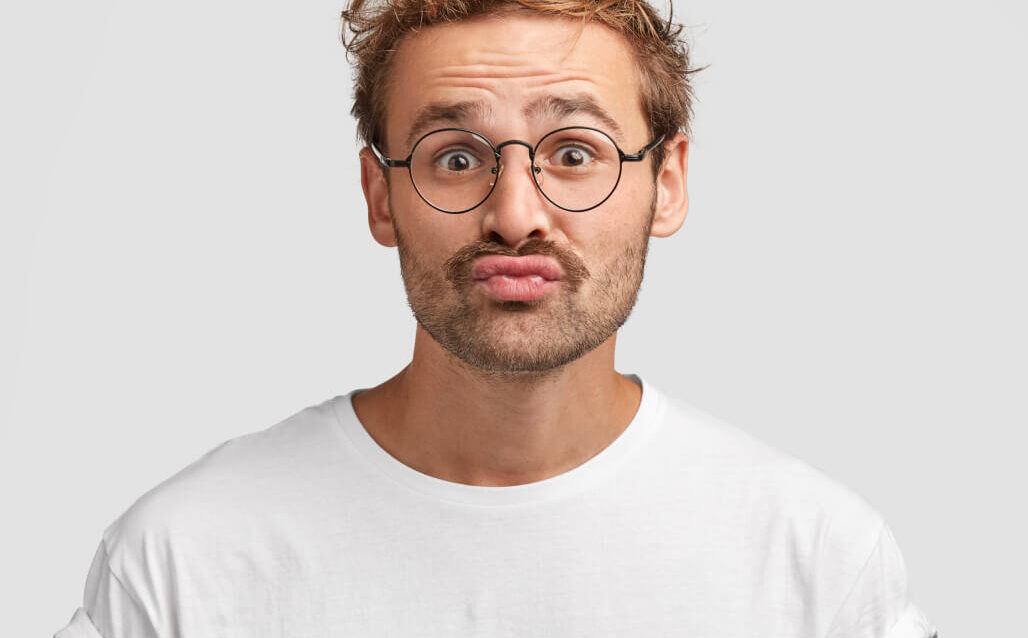 funny-curious-man-makes-grimace-purses-lips-looks-doubtfully 1